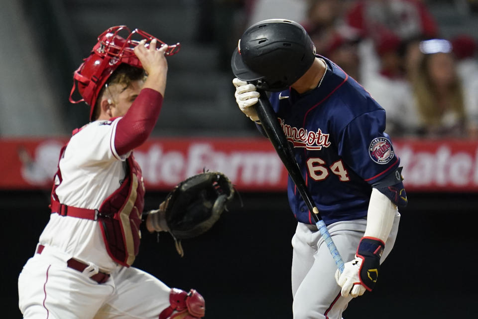 Minnesota Twins designated hitter Jose Miranda (64) kisses his bat as he flies out to center during the fifth inning of a baseball game against the Los Angeles Angels in Anaheim, Calif., Friday, Aug. 12, 2022. (AP Photo/Ashley Landis)