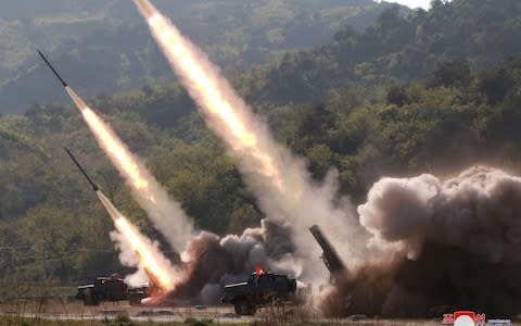 Missiles are seen launched during a military drill in North Korea - Credit: Reuters