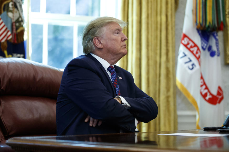 President Donald Trump pauses as he speaks in the Oval Office of the White House in Washington, Friday, July 26, 2019. Trump announced that Guatemala is signing an agreement to restrict asylum applications to the U.S. from Central America.(AP Photo/Carolyn Kaster)