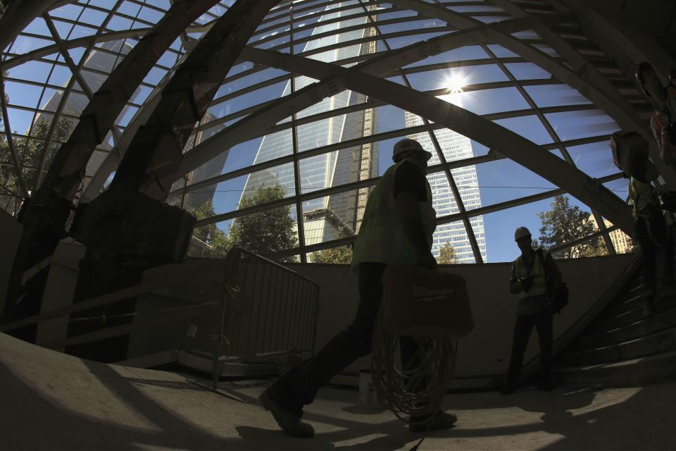 A construction worker walks past two steel "tridents" (L) recovered from the World Trade Center site after September 11, 2001, in the entry pavilion area of the National September 11 Memorial and Museum under construction at the World Trade Center site in New York, September 6, 2013. The Memorial is scheduled to be opened to the public in the spring of 2014. (REUTERS/Brendan McDermid)