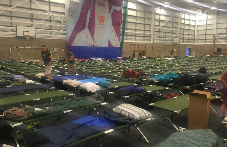 <em>Police securing Donald Trump’s visit slept on lines of camp beds filling a vast gymnasium (Twitter)</em>