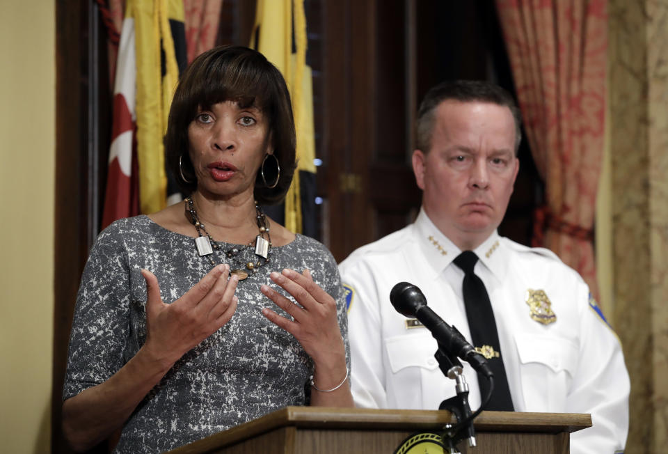 FILE - In this Tuesday, April 4, 2017 file photo, Baltimore Mayor Catherine Pugh, left, speaks alongside Baltimore Police Department Commissioner Kevin Davis at a news conference at City Hall in Baltimore, in response to the Department of Justice's request for a 90-day delay of a hearing on its proposed overhaul of the Baltimore Police Department. An agreement negotiated under the Obama administration to overhaul the troubled Baltimore Police Department will go ahead despite objections from the Trump administration. Pugh disputed the notion the decree will hurt the fight against crime. (AP Photo/Patrick Semansky, File)