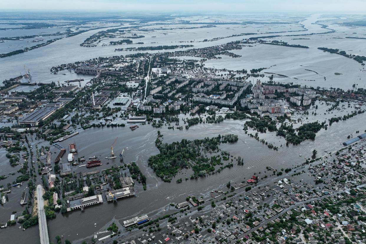 Houses are seen underwater and polluted by oil in a flooded neighborhood in Kherson (Copyright 2020 The Associated Press. All rights reserved)