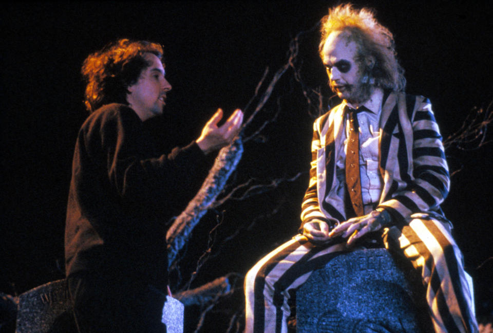 Director Tim Burton gives direction to Michael Keaton in costume as Beetlejuice on the set of the 1988 film. (Alamy)