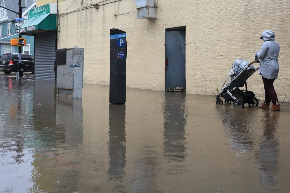 A person pushes a stroller through a flooded Stratford Road amid a coastal storm on September 29, 2023 in the Flatbush neighborhood of Brooklyn borough New York City. Flash flooding is expected in the counties of Nassau, Queens and Kings, which includes Brooklyn, according to the state’s National Weather Service office as remnants of Tropical Storm Ophelia reaches the Northeast. Gov. Kathy Hochul has declared a state of emergency for the NYC area.