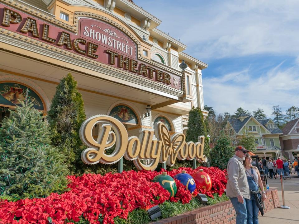 Two people posing in front of Dollywood sign