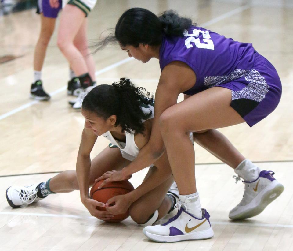 GlenOak's Breezie Williams (left) fights for the ball with Jackson's Leena Patibandla (right) during their game at GlenOak on Wednesday.