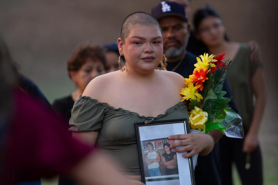 Didi Lopez holds a picture of a young Daniel Piedras Garcia at his vigil at Memorial Park on June 23, 2023. Garcia was fatally shot on US 54 while driving for Uber on June 16, 2023.