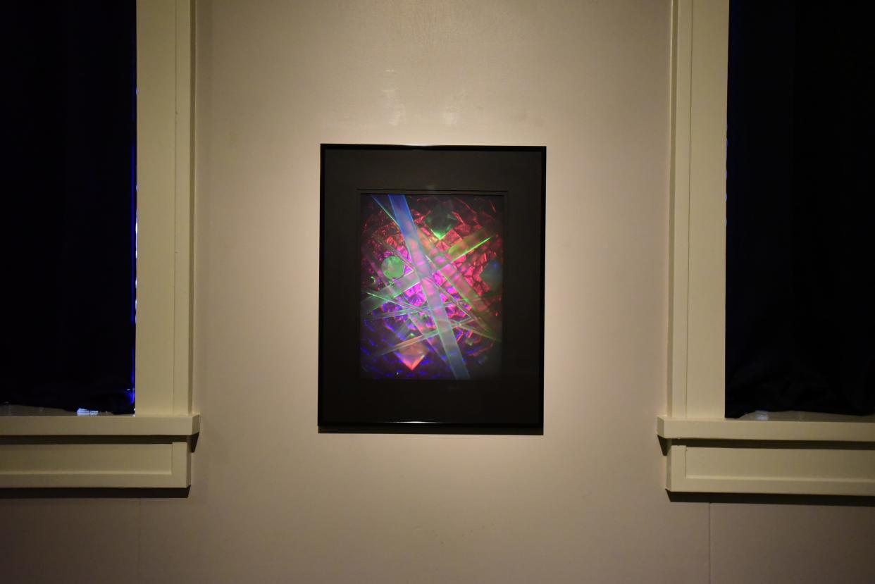 The hologram display of abstract art hangs on a wall as part of the new “Holography: The Michigan Medium” exhibit at the Port Huron Museum on Monday, August 8, 2022. The exhibit showcases the history of holograms, the many types of holograms and how they are used around the world. The exhibit’s goal is to teach people, especially Michigan residents, that holograms were refined in Michigan.