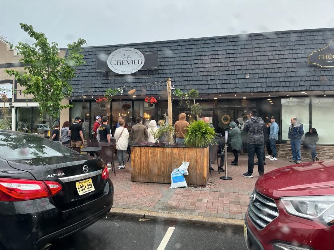 Customers are waiting in line for pizza at Cafe Crevier after influencer Dave Portnoy gave their pie a high score.
