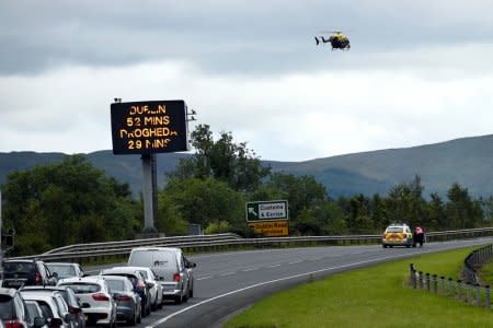 FILE PHOTO: A sign for customs and excise is seen on the motorway approaching the border between Northern Ireland and Ireland, near Newry, Northern Ireland July 13, 2017. REUTERS/Clodagh Kilcoyne