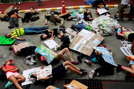 Environmental activist play dead as they participate in a Global Climate Strike near the Ministry of Natural Resources and Environment office in Bangkok