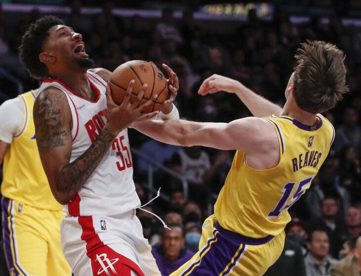 Los Angeles, CA, Tuesday, November 2, 2021 - Houston Rockets center Christian Wood (35) chargers into Los Angeles Lakers guard Austin Reaves (15) during second half action at Staples Center. (Robert Gauthier/Los Angeles Times)