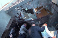 Officials inspect the damage after a bomb blast in Lashio, Myanmar February 21, 2018 in this picture obtained from social media. Ministry of Information Webportal Myanmar/via REUTERS