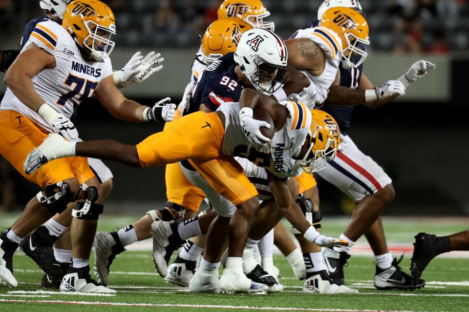 Arizona Wildcats defensive lineman Tyler Manoa (92) makes a tackle against UTEP Miners running back Torrance Burgess Jr. (5) during the second half at Arizona Stadium in Tucson on Sept. 16, 2023.