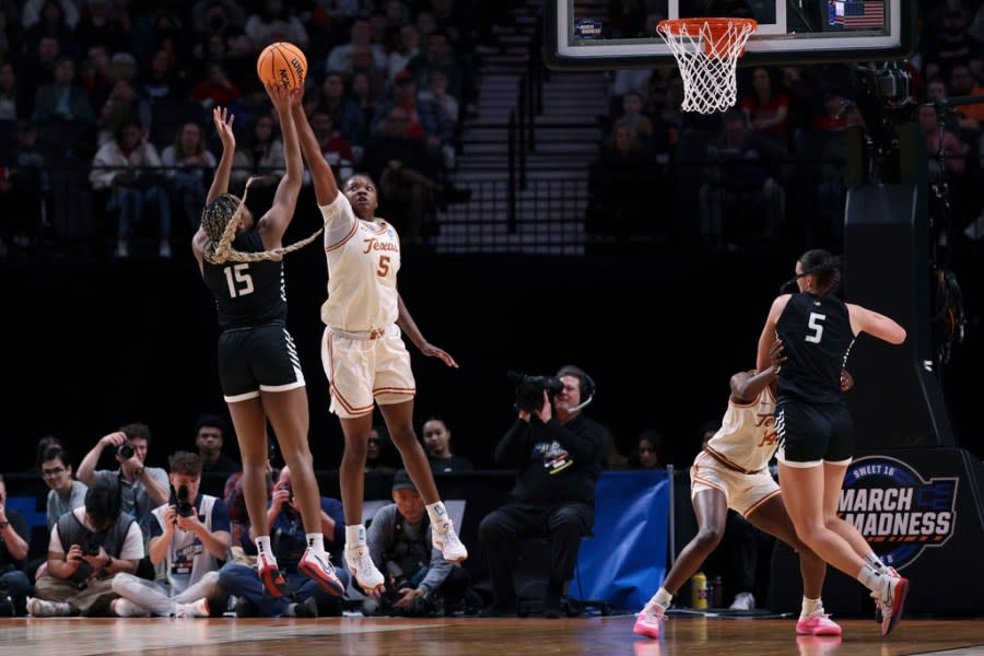Gonzaga forward Yvonne Ejim (15) shoots as Texas forward DeYona Gaston (5) defends during the second half of a Sweet 16 college basketball game in the women’s NCAA Tournament, Friday, March 29, 2024, in Portland, Ore. (AP Photo/Howard Lao)