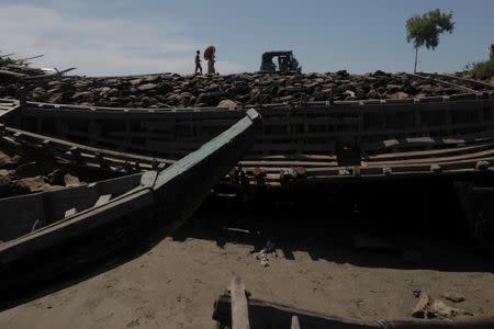 Remnants of some 20 boats that ferried Rohingya refugees fleeing violence in Myanmar, which were destroyed by Bangladeshi authorities the night before, are seen at Shah Porir Dwip near Cox's Bazar, Bangladesh October 4, 2017. REUTERS/Damir Sagolj