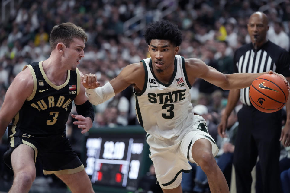 Michigan State guard Jaden Akins (3) drives as Purdue guard Braden Smith (3) defends during the second half of an NCAA college basketball game, Monday, Jan. 16, 2023, in East Lansing, Mich. (AP Photo/Carlos Osorio)