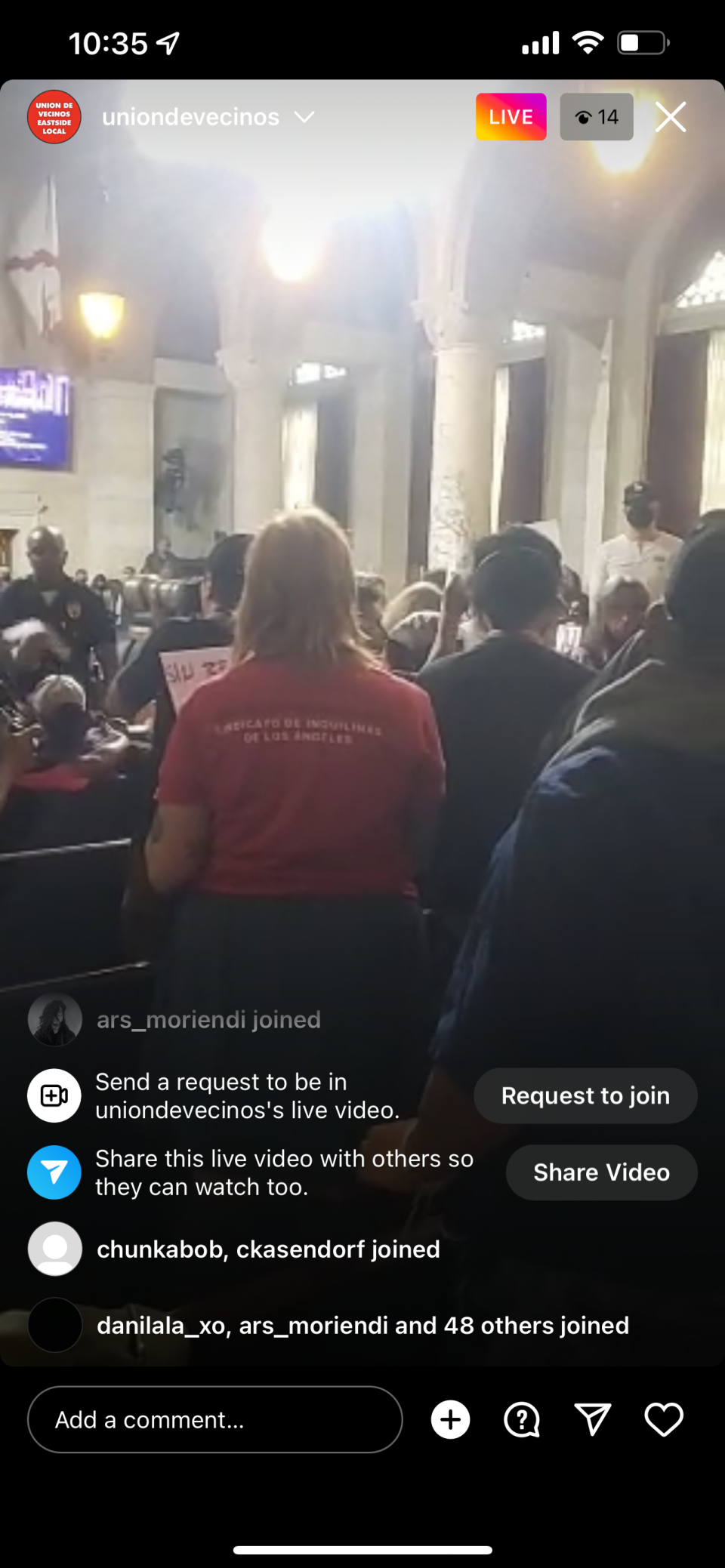 A screenshot of the Instagram live footage shows a packed council chamber.