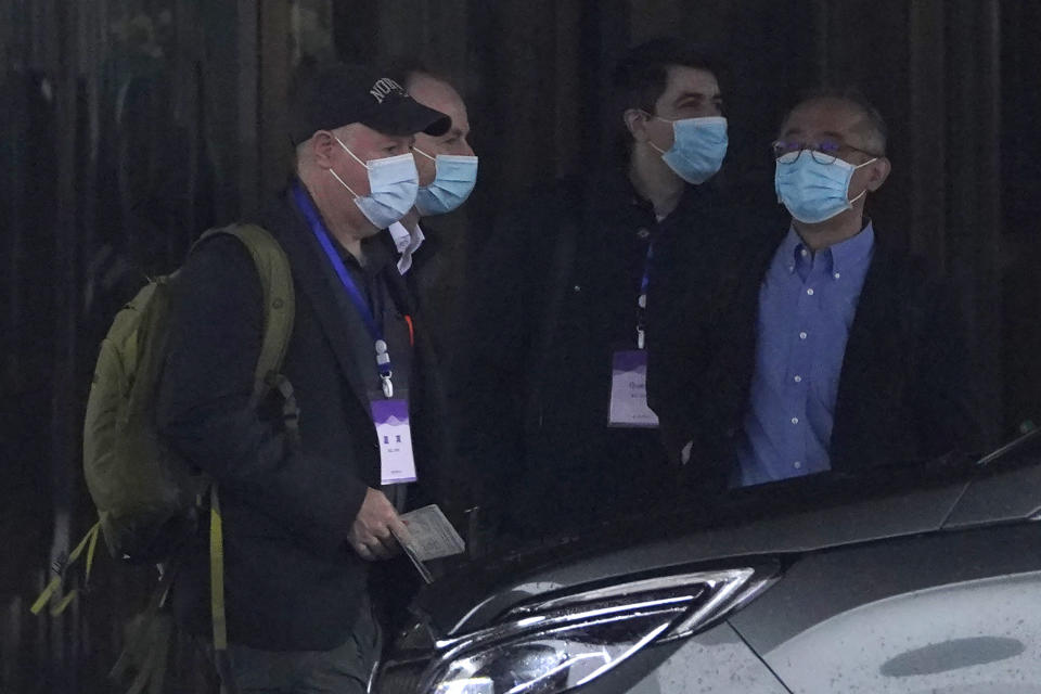 Members of the World Health Organization team including Peter Daszak, left, Ken Maeda, right, and Vladimir Dedkov, second right, prepare to leave for a fourth day of field visits from their hotel in Wuhan in central China's Hubei province on Monday, Feb. 1, 2021. (AP Photo/Ng Han Guan)