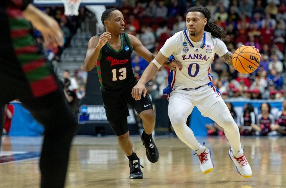 Kansas guard Bobby Pettiford Jr. (0) drives against Howard guard Thomas Weaver (13) during a first-round college basketball game in the NCAA Tournament Thursday, March 16, 2023, in Des Moines, Iowa.