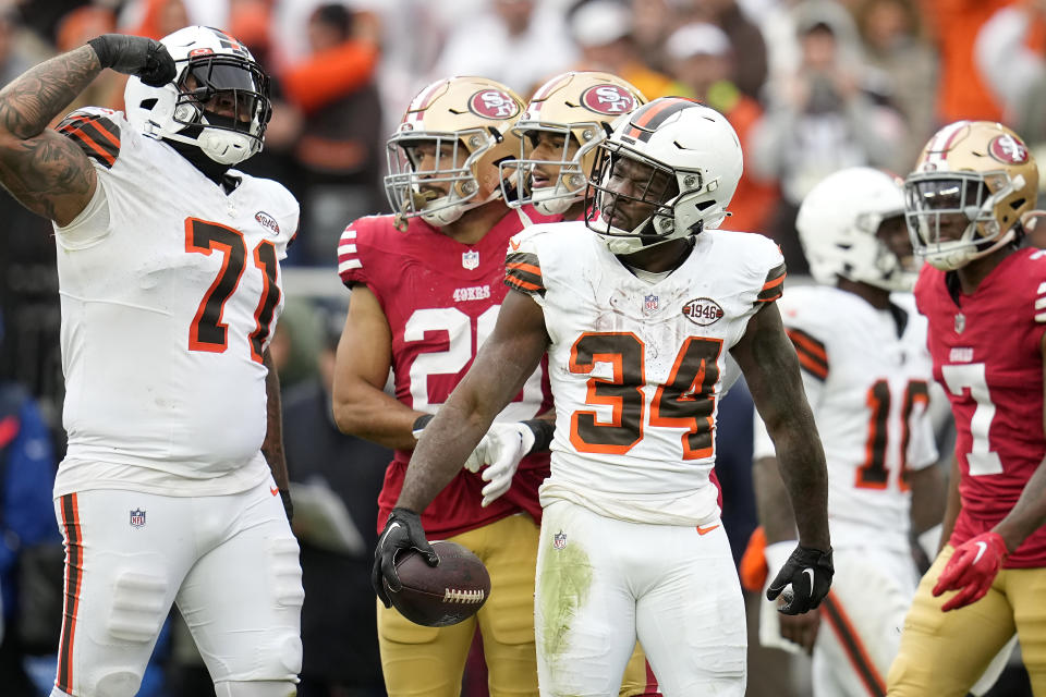 Cleveland Browns offensive tackle Jedrick Wills Jr. (71) and running back Jerome Ford (34) react during the second half of an NFL football game against the San Francisco 49ers Sunday, Oct. 15, 2023, in Cleveland. (AP Photo/Sue Ogrocki)