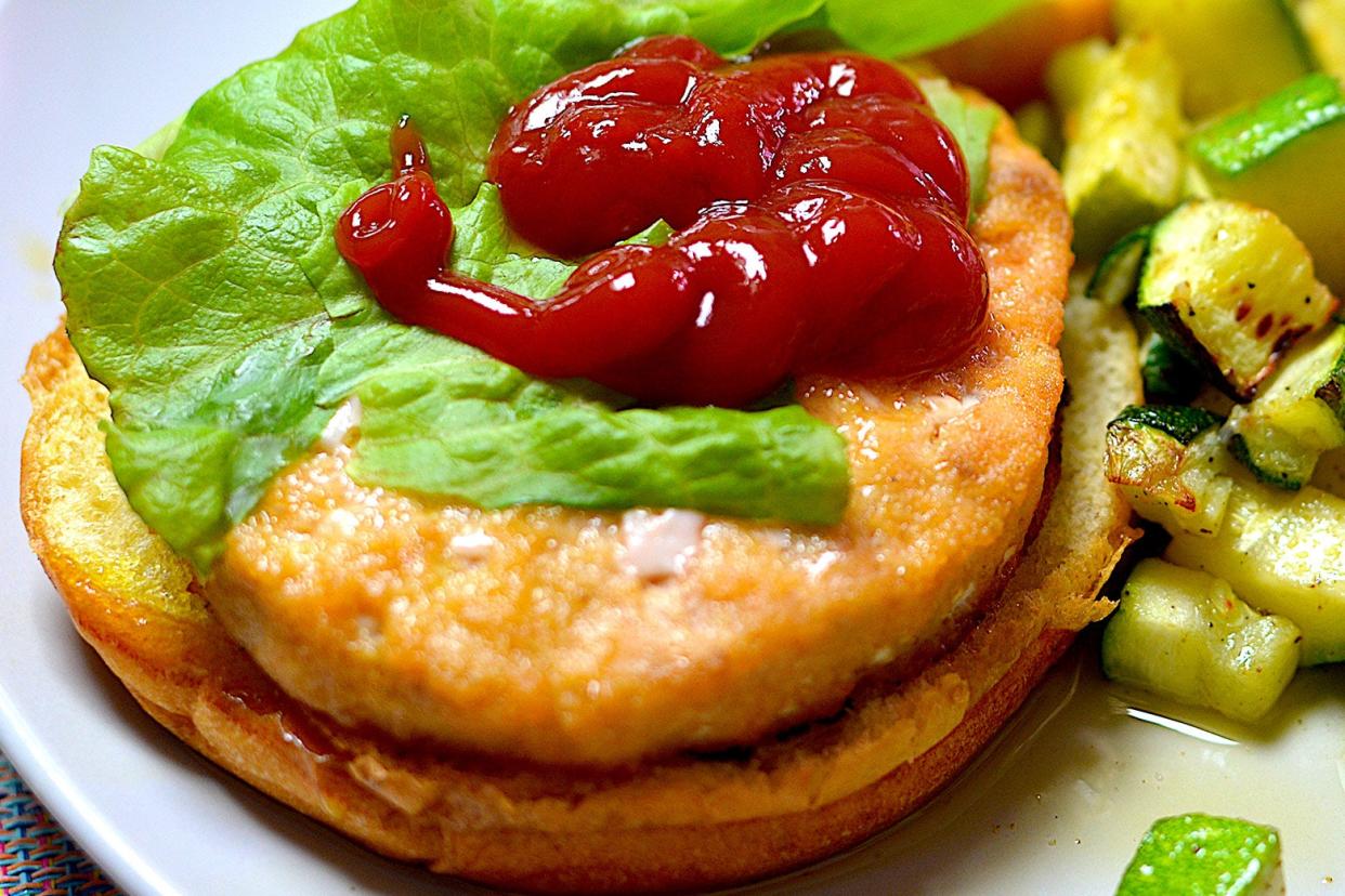 A salmon burger topped with ketchup, a Mitt Romney favorite. 