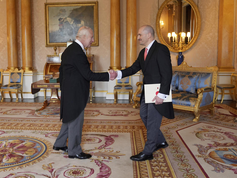 Uran Ferizi, Ambassador from the Republic of Albania, right, presents his credentials to Britain's King Charles III during a private audience at Buckingham Palace, London, Thursday May 30, 2024. (Yui Mok/Pool Photo via AP)