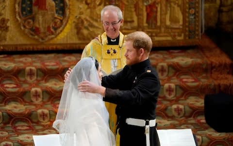 Prince Harry pulls back the veil of Meghan Markle - Credit: AP