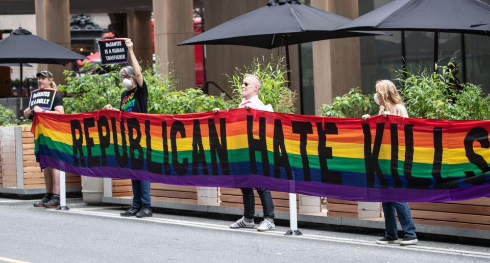Protestors stand across the street from the Yale Club in Manhattan June 29, 2023 before Florida Governor  and presidential candidate Ron DeSantis arrived for a private fundraiser.