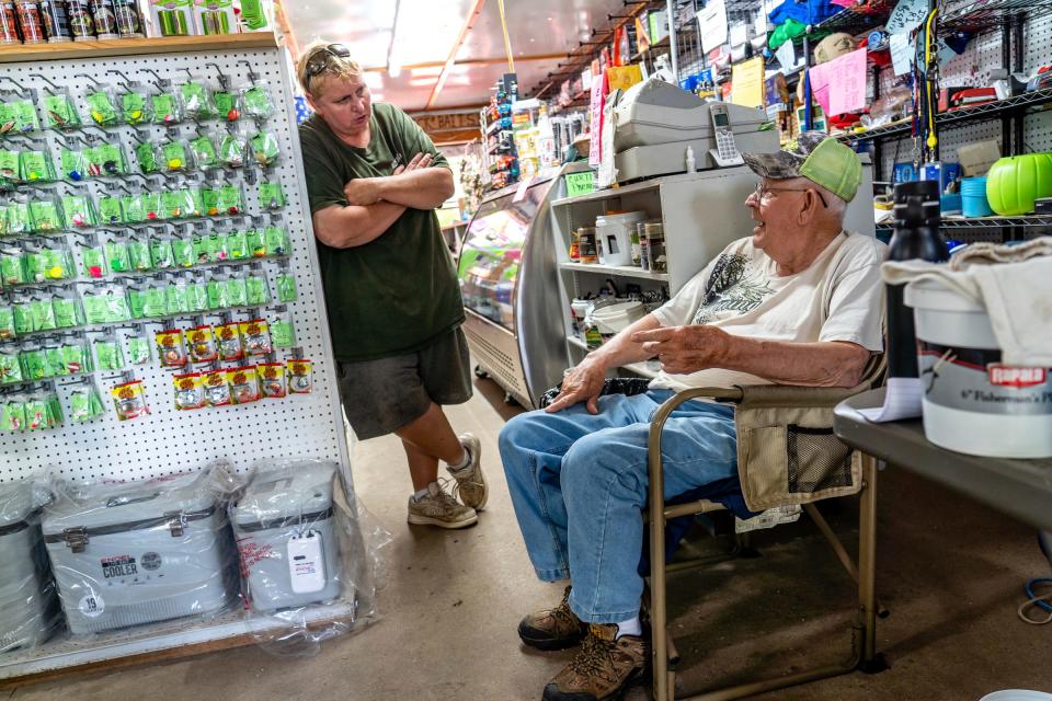 Mick's Bait Shop owner Mick Treiber, 56, talks with Tod Lindquist, 79, of Portage during his visit to Mick's Bait Shop in Curtis, located in the Upper Peninsula, on Tuesday, July 25, 2023. Lindquist has been shopping at the store for over two decades.