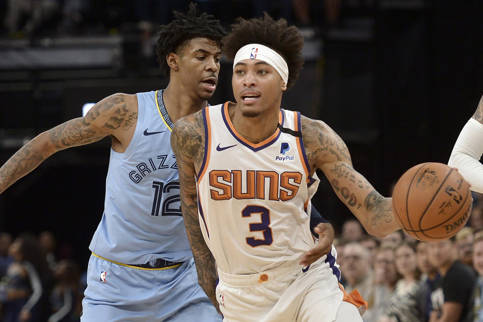 Phoenix Suns forward Kelly Oubre Jr. (3) handles the ball ahead of Memphis Grizzlies guard Ja Morant (12) in the second half of an NBA basketball game Sunday, Jan. 26, 2020, in Memphis, Tenn. (AP Photo/Brandon Dill)