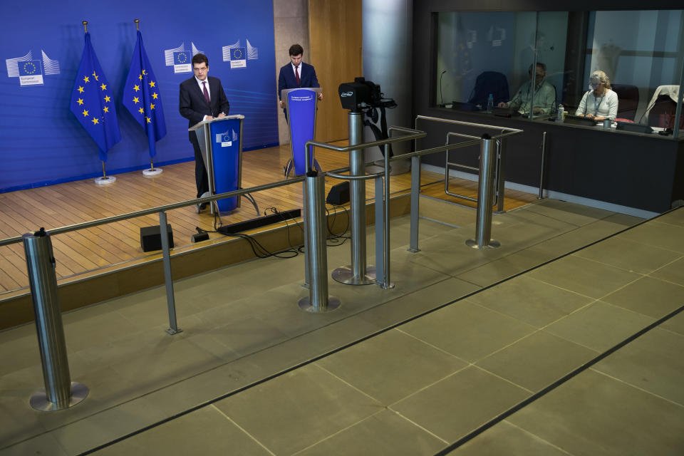 European Commissioner for Crisis Management Janez Lenarcic, left, talks during a news conference at the EU headquarters during a partial lockdown against the spread of the Covid-19 coronavirus in Brussels, Tuesday, April 7, 2020. The new coronavirus causes mild or moderate symptoms for most people, but for some, especially older adults and people with existing health problems, it can cause more severe illness or death. (AP Photo/Francisco Seco)