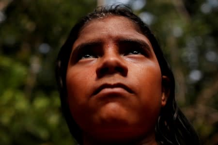 An indigenous from the Mura tribe reacts in front a deforested area in nondemarcated indigenous land inside the Amazon rainforest near Humaita
