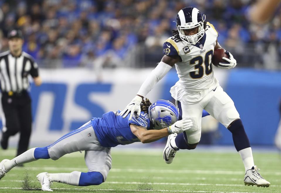 FILE - In this Sunday, Dec. 2, 2018, file photo, Los Angeles Rams running back Todd Gurley (30) pulls away from Detroit Lions defensive back Mike Ford during the first half of an NFL football game in Detroit. Gurley finds himself in exclusive company. He has gained 1,649 yards from scrimmage and scored 19 TDs so far this season. Only six players have topped those marks in the first 12 games. (AP Photo/Rey Del Rio, File)