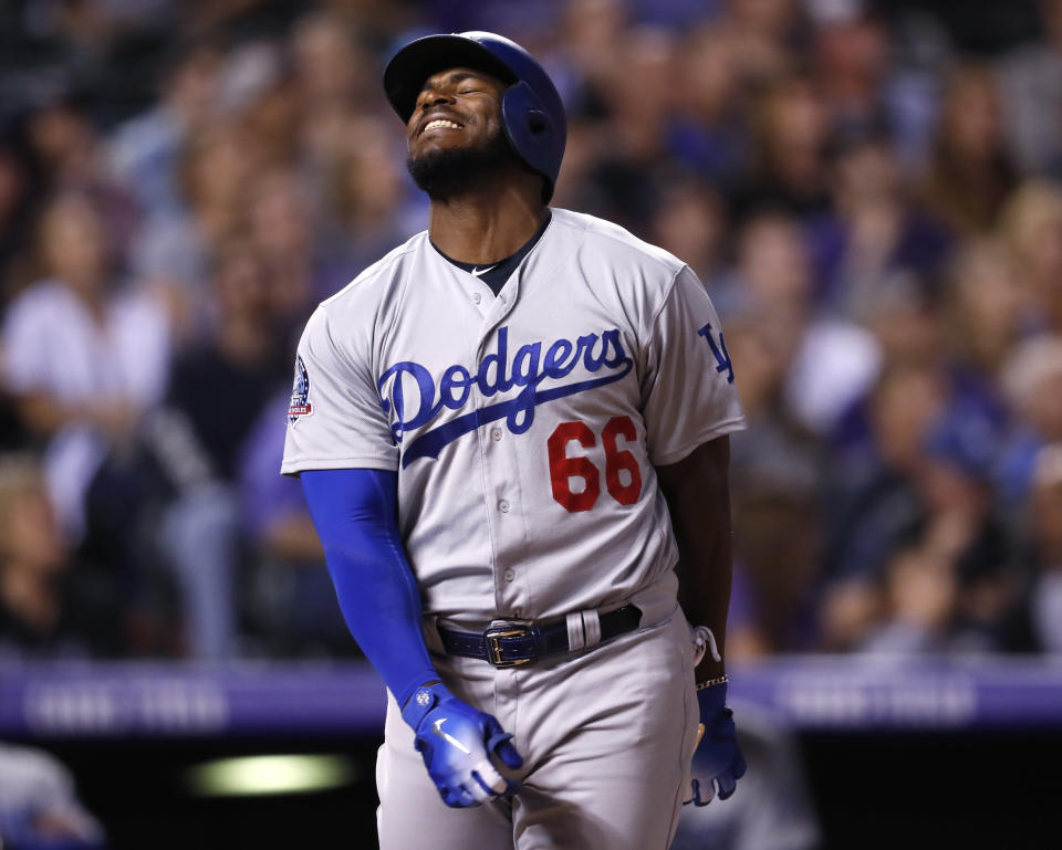 Los Angeles Dodgers' Yasiel Puig reacts after flying out against Colorado Rockies starting pitcher Jon Gray in the fourth inning of a baseball game Friday, Sept. 7, 2018, in Denver. (AP Photo/David Zalubowski)