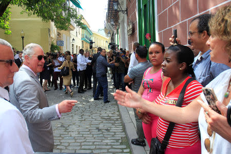 Britain's Prince Charles talk to people on the street as he visits Old Havana, Cuba, March 25, 2019. REUTERS/Stringer NO RESALES. NO ARCHIVE