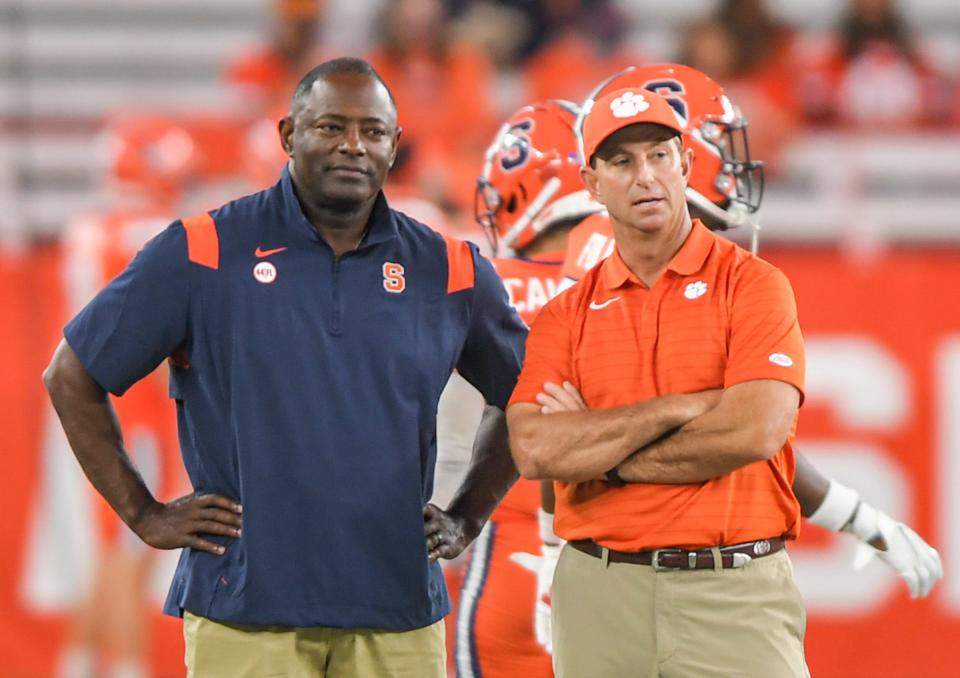 Syracuse Head Football Coach Dino Babers  and Clemson head coach Dabo Swinney talks as the team practices before the game at the Carrier Dome in Syracuse, New York, Friday, October 15, 2021.