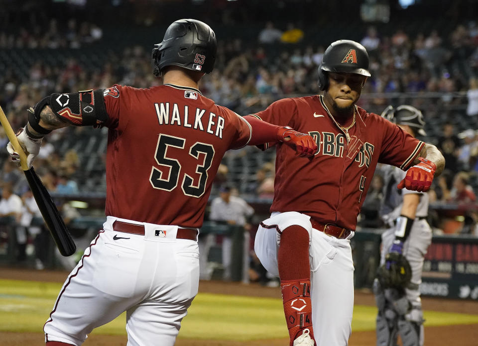 Arizona Diamondbacks' Ketel Marte (4) celebrates his home run against the Colorado Rockies with teammate Christian Walker (53) during the first inning of a baseball game, Sunday July 10, 2022, in Phoenix.(AP Photo/Darryl Webb)