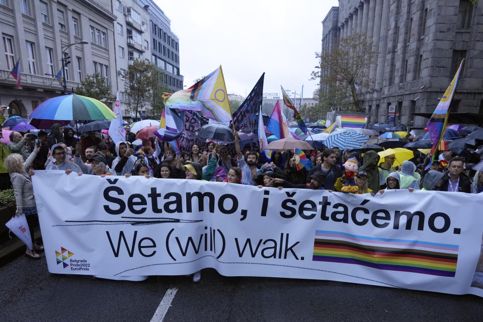 Participants take part in the European LGBTQ pride march in Belgrade, Serbia, Saturday, Sept. 17, 2022. Serbian police have banned Saturday's parade, citing a risk of clashes with far-right activists. (AP Photo/Darko Vojinovic)