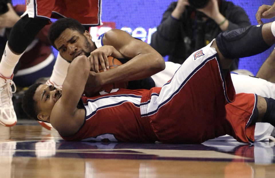 Saint Louis' Dwayne Evans, top, competes for a loose ball with Duquesne's Jeremiah Jones in the first half of an NCAA college basketball game, Thursday, Feb. 27, 2014, in St. Louis. (AP Photo/Tom Gannam)