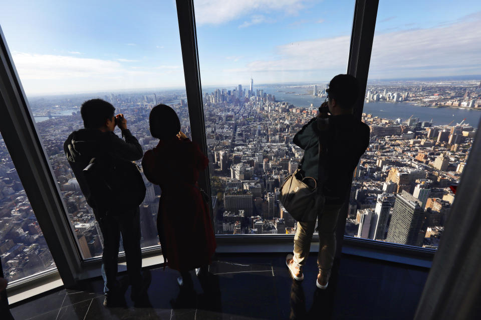 People look at the south view in the 102nd floor Observatory of the Empire State Building, in New York, Thursday, Oct. 10, 2019. (AP Photo/Richard Drew)