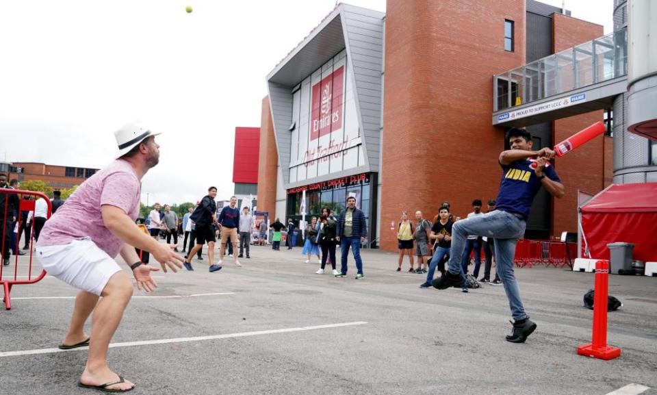 Fans play cricket outside the ground after India forfeited the fifth Test.
