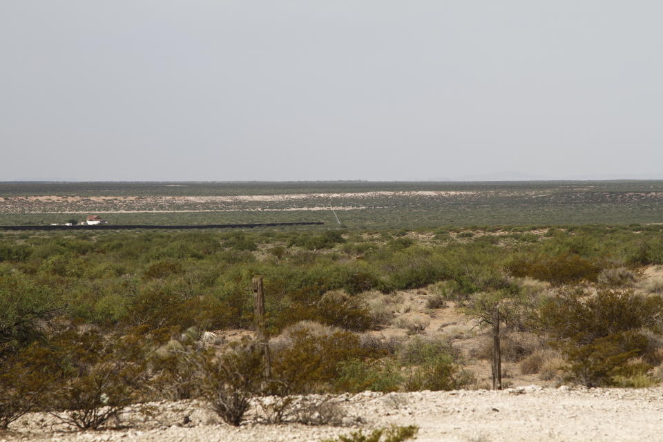 A crane can be seen at the beginning of new border wall construction about 20 miles west of Santa Teresa, New Mexico, Aug. 23, 2019. The wall visible on the left was built in 2018 with money allocated by Congress, while the new construction is funded by money reallocated from Department of Defense funding. (AP Photo/Cedar Attanasio)