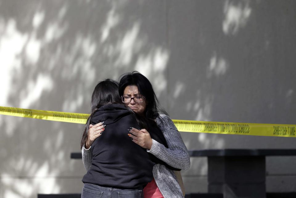 Mourners embrace outside of the Thousand Oaks Teen Center on Thursday, Nov. 8, 2018, where relatives and friends gathered in the aftermath of the Wednesday night mass shooting, in Thousand Oaks, Calif. Multiple people were shot and killed late Wednesday by a gunman who opened fire at the Borderline Bar & Grill, which was holding a weekly country music dance night for college students. (AP Photo/Marcio Jose Sanchez)