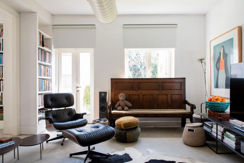 The lounge corner is outfitted with an Eames Lounge Chair and Ottoman, a church pew sourced from a local antique shop, and a smattering of Broudo’s knitting projects. The painting is by local artist Erez Golan.