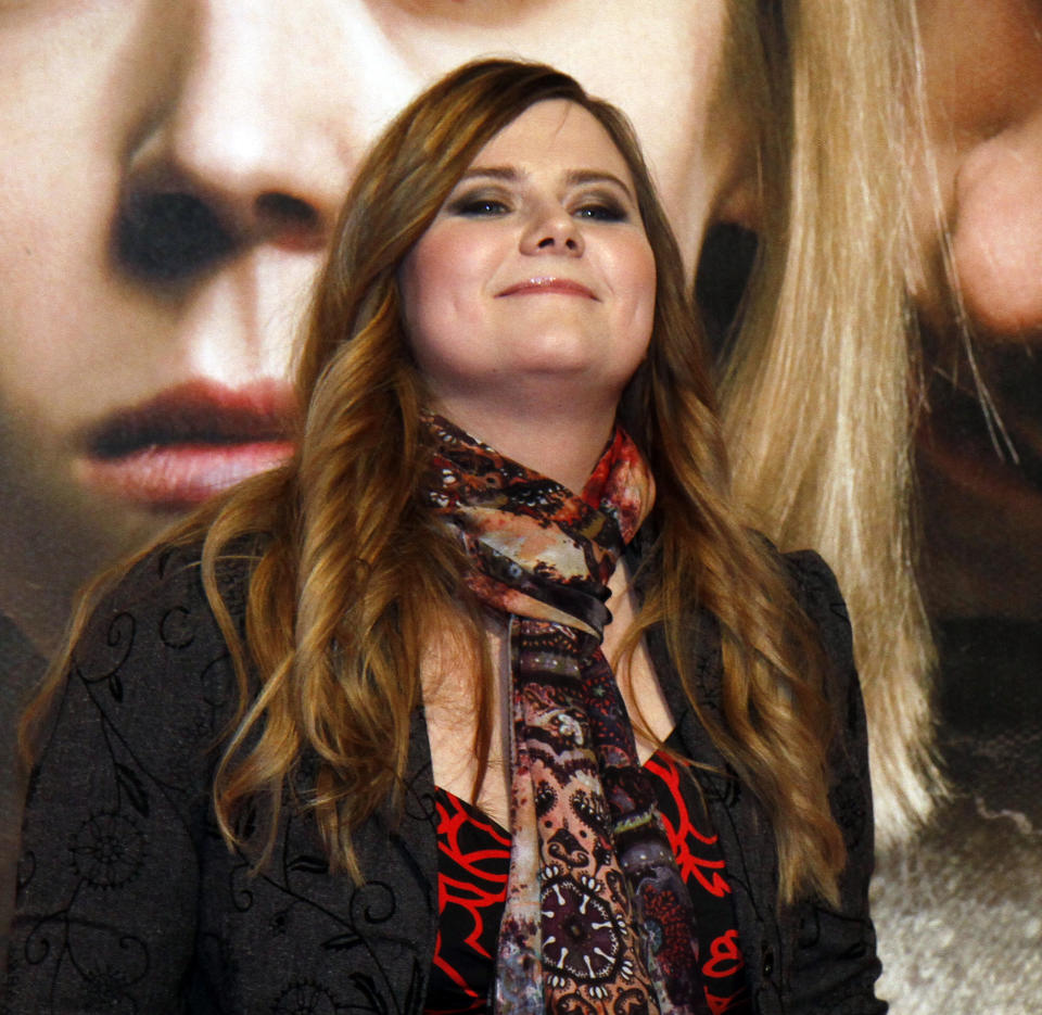 Austrian Natascha Kampusch poses for photographers before the premiere of the film "3096 Days" in Vienna, Austria, Monday Feb. 25, 2013. The film tells the story of Kampusch who was abducted as a schoolgirl and held prisoner in a cellar for almost nine years. (AP Photo/Ronald Zak)