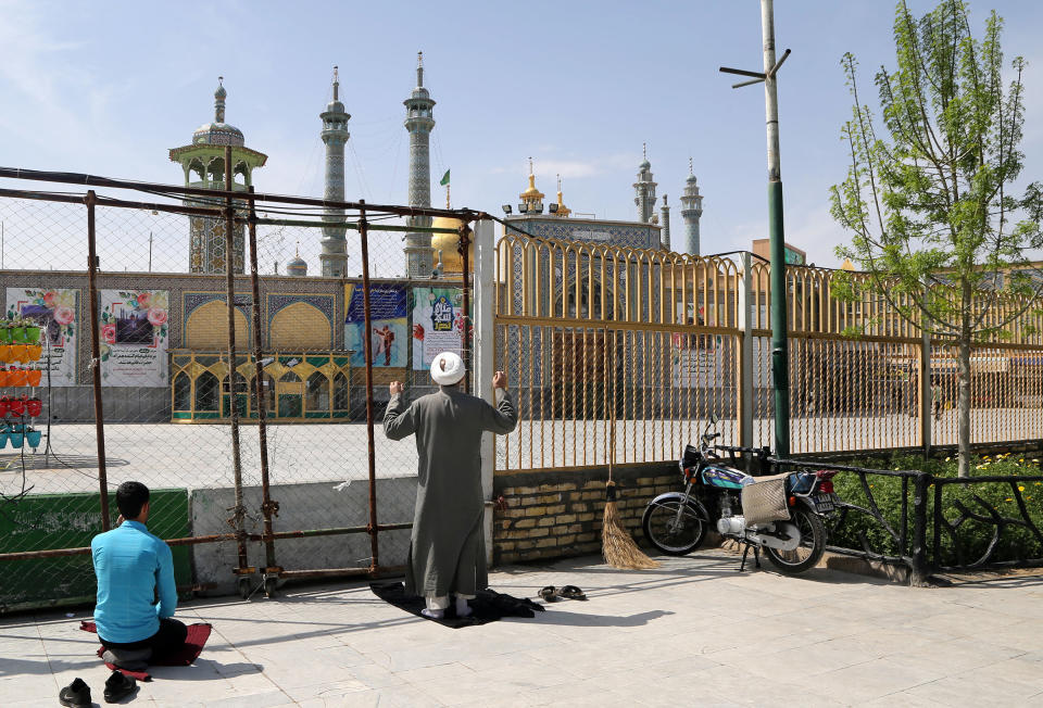 People continue to pray outside of Fatima Masumeh Shrine as it is closed for visitors due to the spread of COVID-19 in Qom, Iran on March 17. | Photo by Fatemah Bahrami—Anadolu Agency/Getty Images