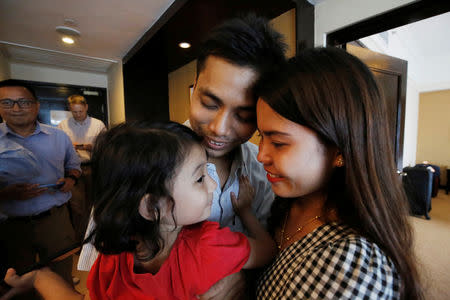 Reuters reporter Kyaw Soe Oo celebrates with his wife and daughter after being freed from prison, after receiving a presidential pardon in Yangon, Myanmar, May 7, 2019. REUTERS/Ann Wang/Pool