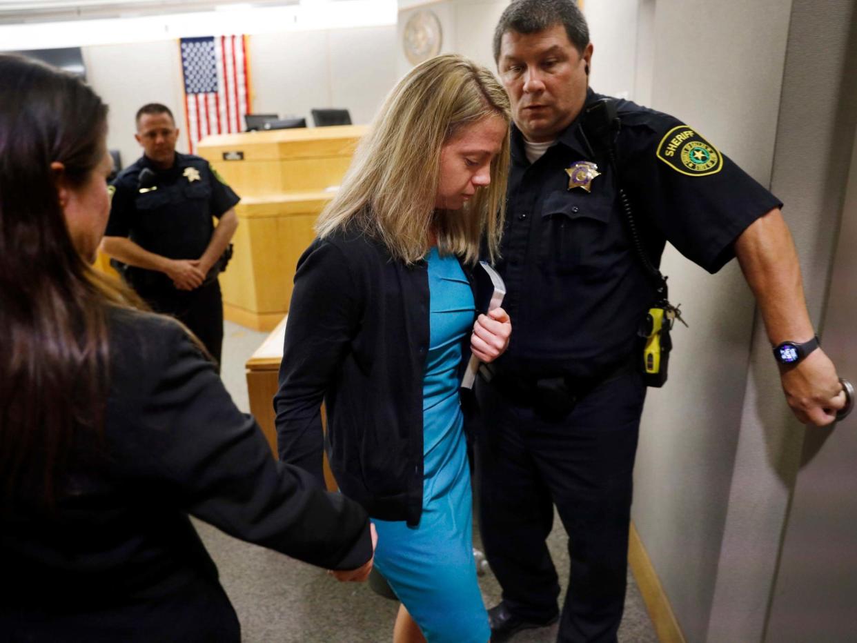 Amber Guyger leaves court after being sentenced to a decade in prison for murder clutching a bible given to her by the judge, Tammy Kent: Tom Fox/The Dallas Morning News via AP, Pool